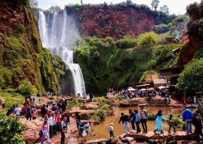 Ouzoud Waterfalls cascading into a green canyon, a scenic natural stop on a High Atlas itinerary.
