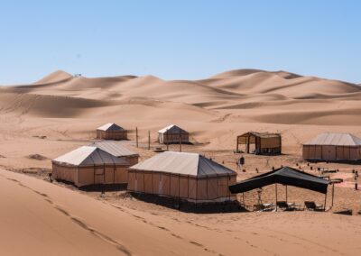 Camel caravan crossing the dunes of Merzouga at sunset, a breathtaking endpoint on an Atlas itinerary.