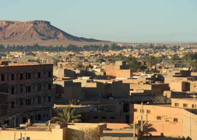 Panoramic view of the Ziz Valley with palm groves and mountain cliffs, a dramatic stretch on an Atlas itinerary.