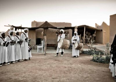 Gnawa musicians performing in Khamlia near Merzouga, a cultural highlight on an extended Atlas itinerary.