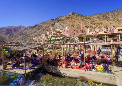 Scenic view of the Ourika Valley with river and Berber villages, a lush starting point on an Atlas itinerary.