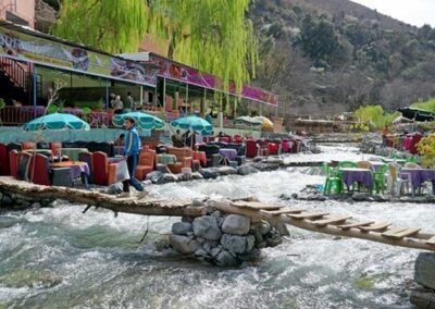 Scenic view of the Ourika Valley with river and Berber villages, a lush starting point on an Atlas itinerary.