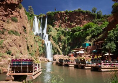 Ouzoud Waterfalls cascading into a green canyon, a scenic natural stop on a High Atlas itinerary.
