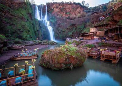 Ouzoud Waterfalls cascading into a green canyon, a scenic natural stop on a High Atlas itinerary.