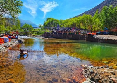 Scenic view of the Ourika Valley with river and Berber villages, a lush starting point on an Atlas itinerary.