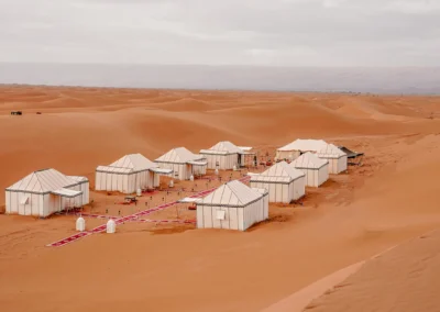 Camel caravan crossing the dunes of Merzouga at sunset, a breathtaking endpoint on an Atlas itinerary.