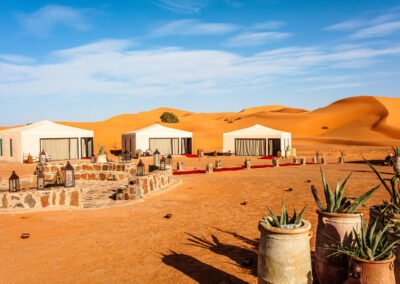 Camel caravan crossing the golden sand dunes of the Merzouga Sahara desert Atlas Itinerary