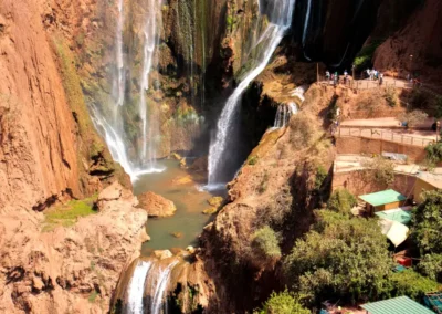 Ouzoud Waterfalls cascading into a green canyon, a scenic natural stop on a High Atlas itinerary.